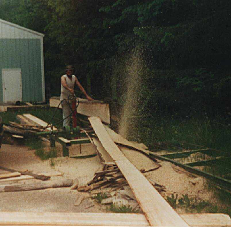 Rich cutting the logs to build his home. 