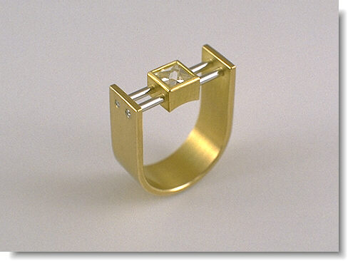 A context cut ring made of gold and platinum.