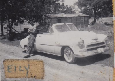 Ernie standing with his first convertible (side view).