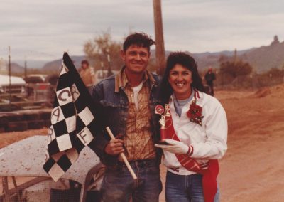 Ernie with checkered flag and victory trophy.