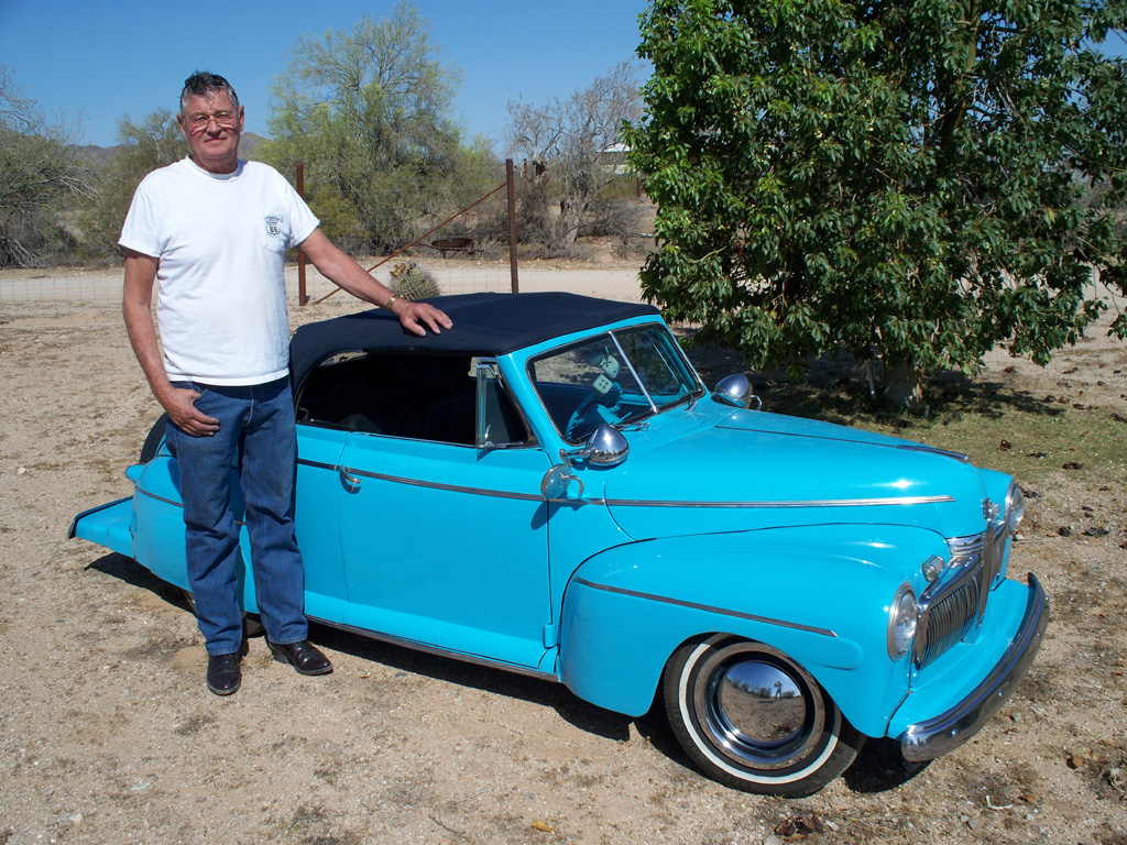 Ernie standing with his '42 Ford Deluxe Convertible.