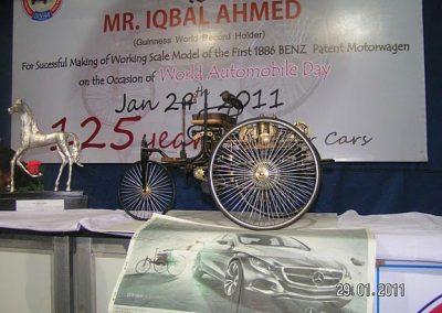 The motorwagen next to Iqbal's trophy.