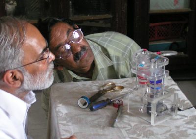 Iqbal and friend examining the human heart pump.