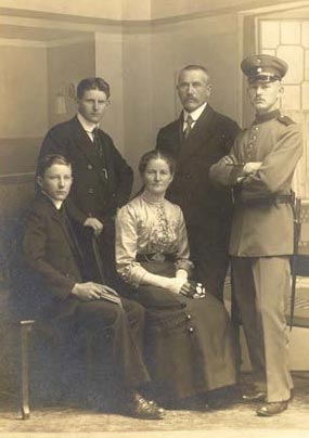 John standing at left in a family photo.