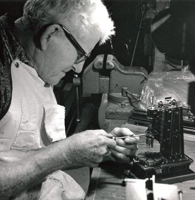 John Aschauer working on a miniature machine tool model.