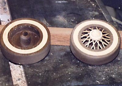 Wooden wheels and tires for a model car.