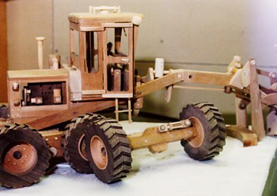 Side view of partially assembled road grader.