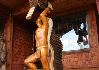 Native American with eagle sculpture.