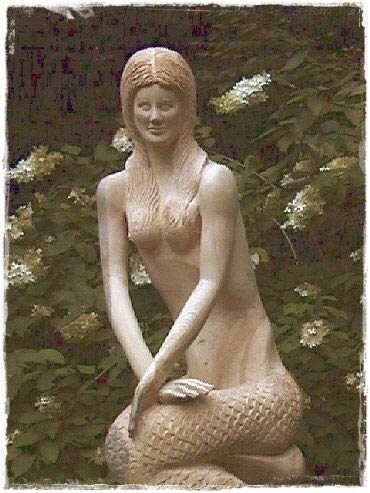 Mermaid carving in a garden.