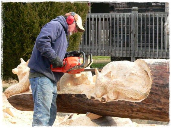 Randy carving out a sculpture with his chainsaw.