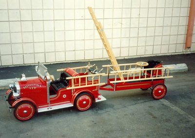Ford Model A fire truck with ladder extended.