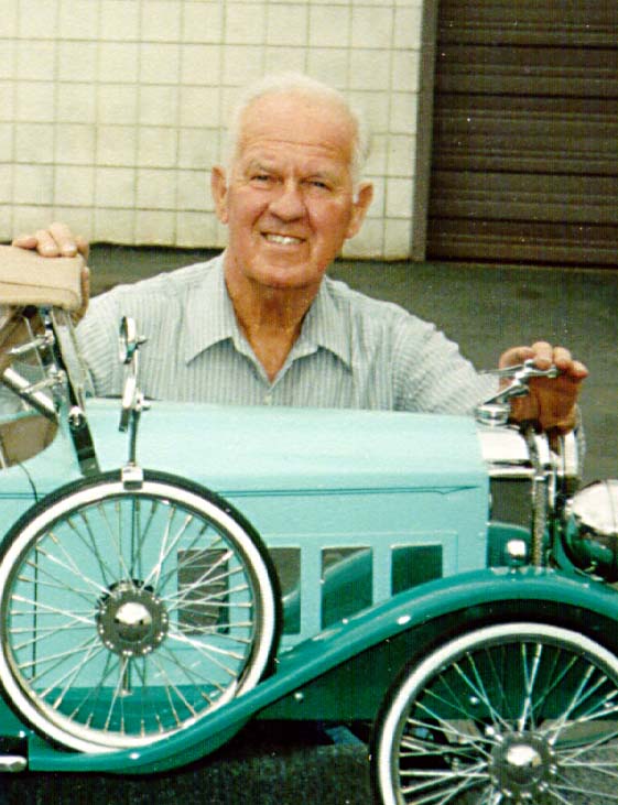 Bill posing behind one of his pedal cars. 