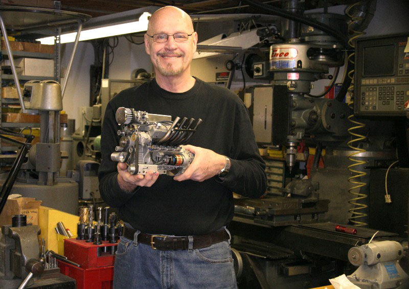 Gary holding the new Stinger V-8 while standing in front of his CNC milling machine.