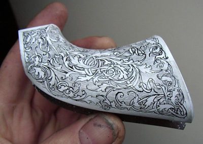 Colt revolver handgrip carving.
