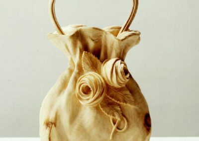 A carved wooden purse.