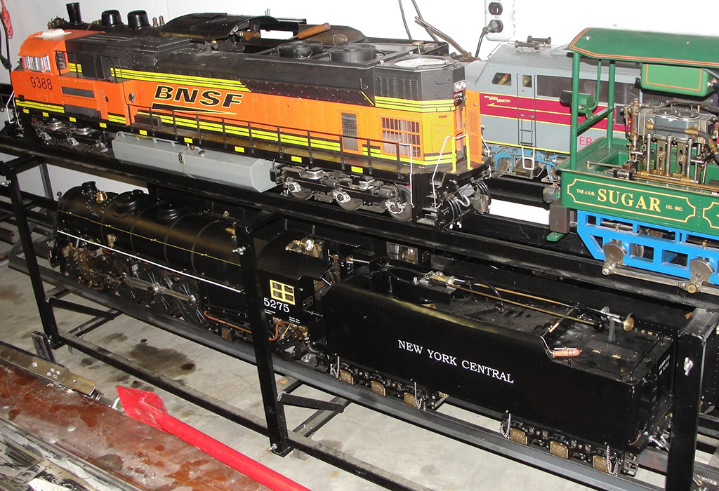 A Burlington Northern Santa Fe Engine sits on the top left of this storage rack. 