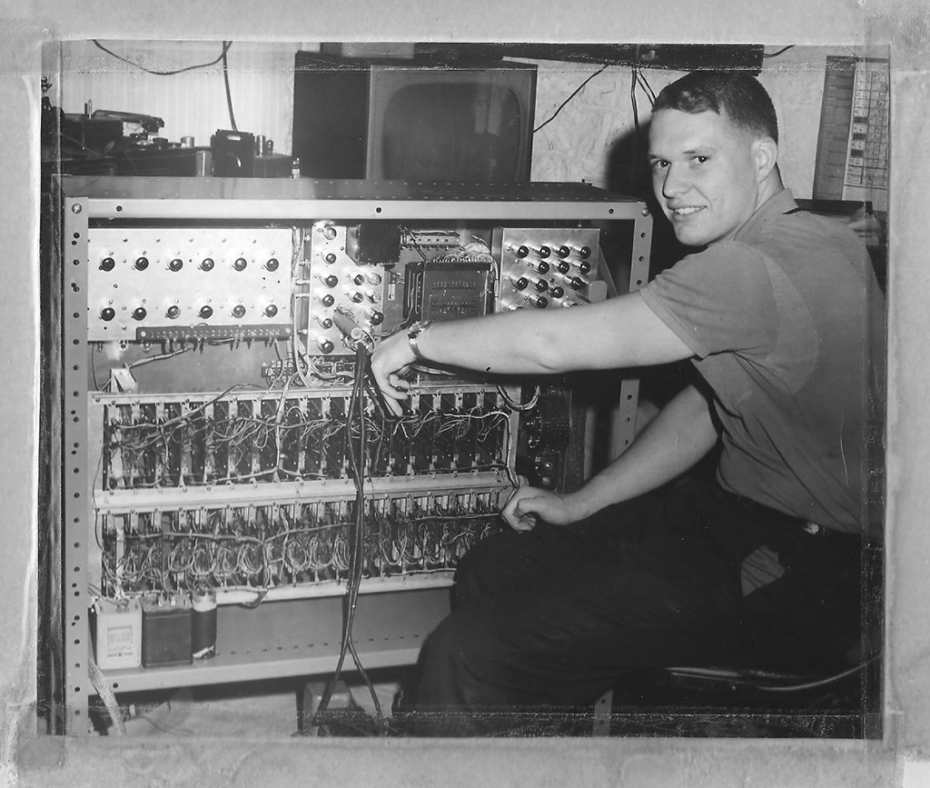 A young Chuck Balmer working on electronics. 