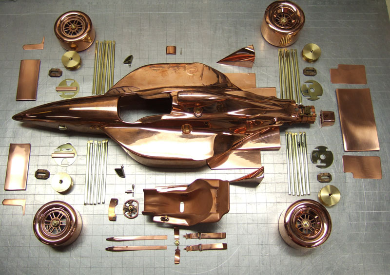 An array of components for the gold car model. 