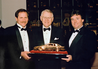 Dale Earnhardt receiving the gold car award built by Mike.