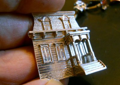 A small silver Victorian house made by Bryan.