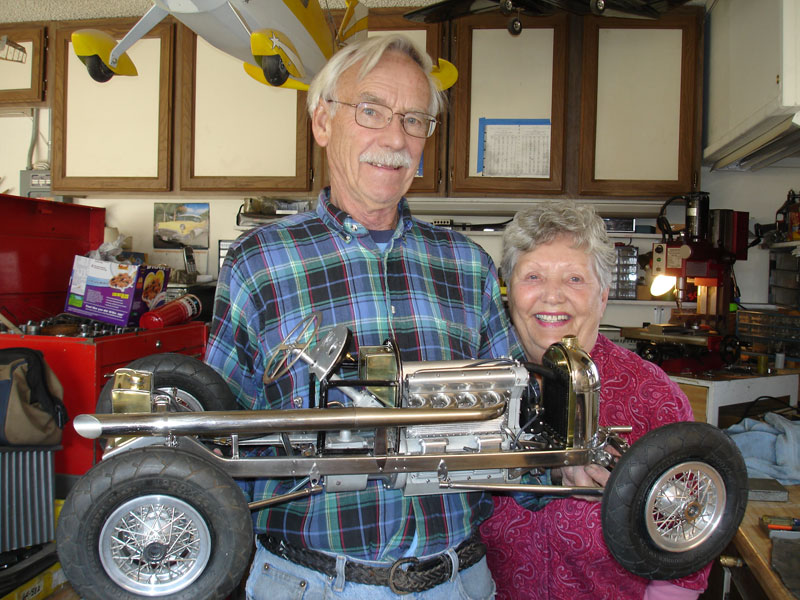 Ron and his wife with the uncovered scale race car.