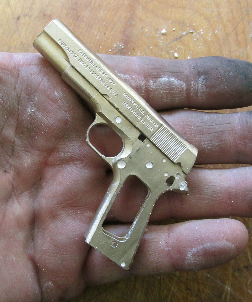 A miniature Colt M1911 cast frame and slide. 