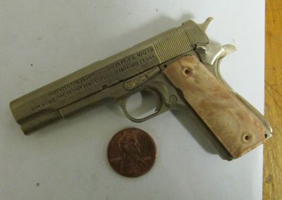 A fully assembled scale pistol with grip.