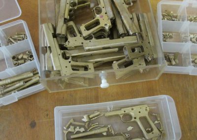 Sets of finished parts for the scale Colt pistols.