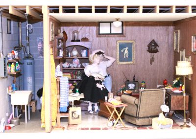 A tiny model basement recreation room with 1950's themes.