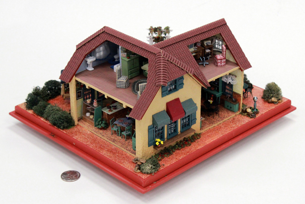 A miniature dollhouse model of Mimi's Cafe.