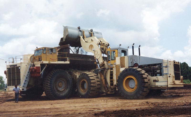A full-size front-end loader and dump truck, which Perry modeled in miniature.