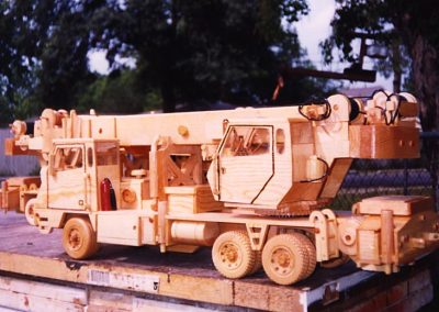A wooden three-axle crane truck.