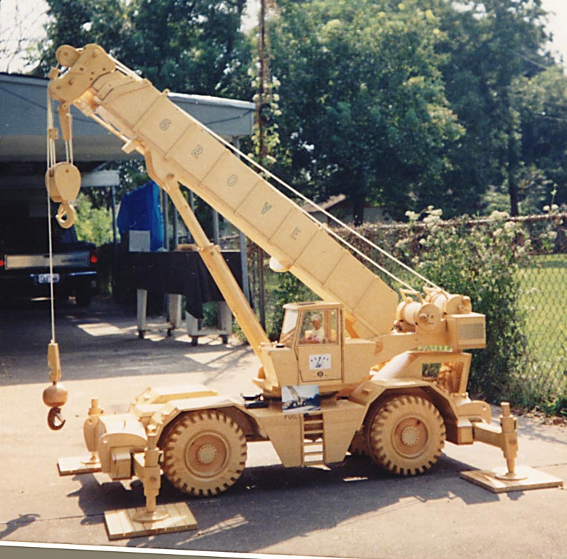A scale model Grove utility crane sits in the driveway.
