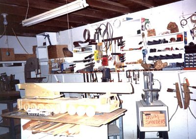 Perry's wood shop, with a model on the table.