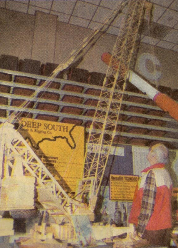 Perry standing beside his model Deep South crane.