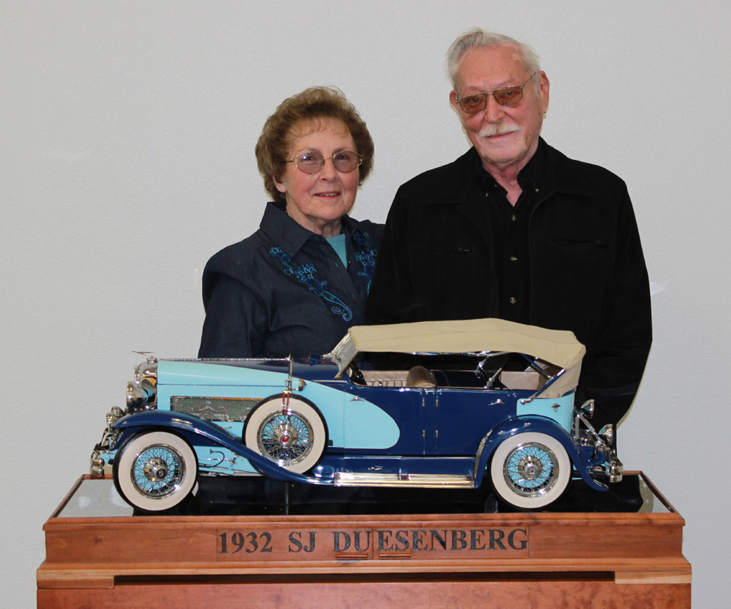 June and Louis Chenot stand behind the 1/6 scale Duesenberg.