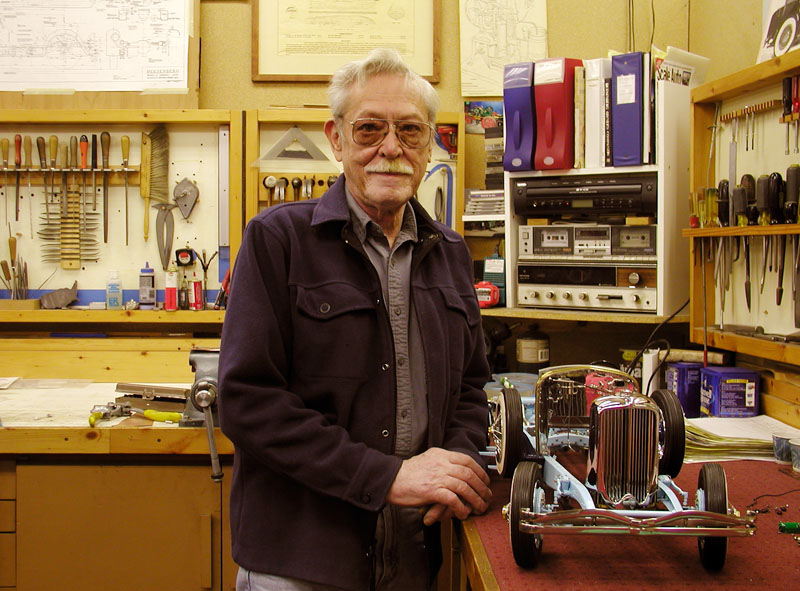 Lou Chenot stands in his shop with the partially completed Duesenberg.