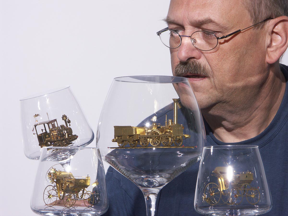 Szymon examines some of his intricate brass miniatures. 