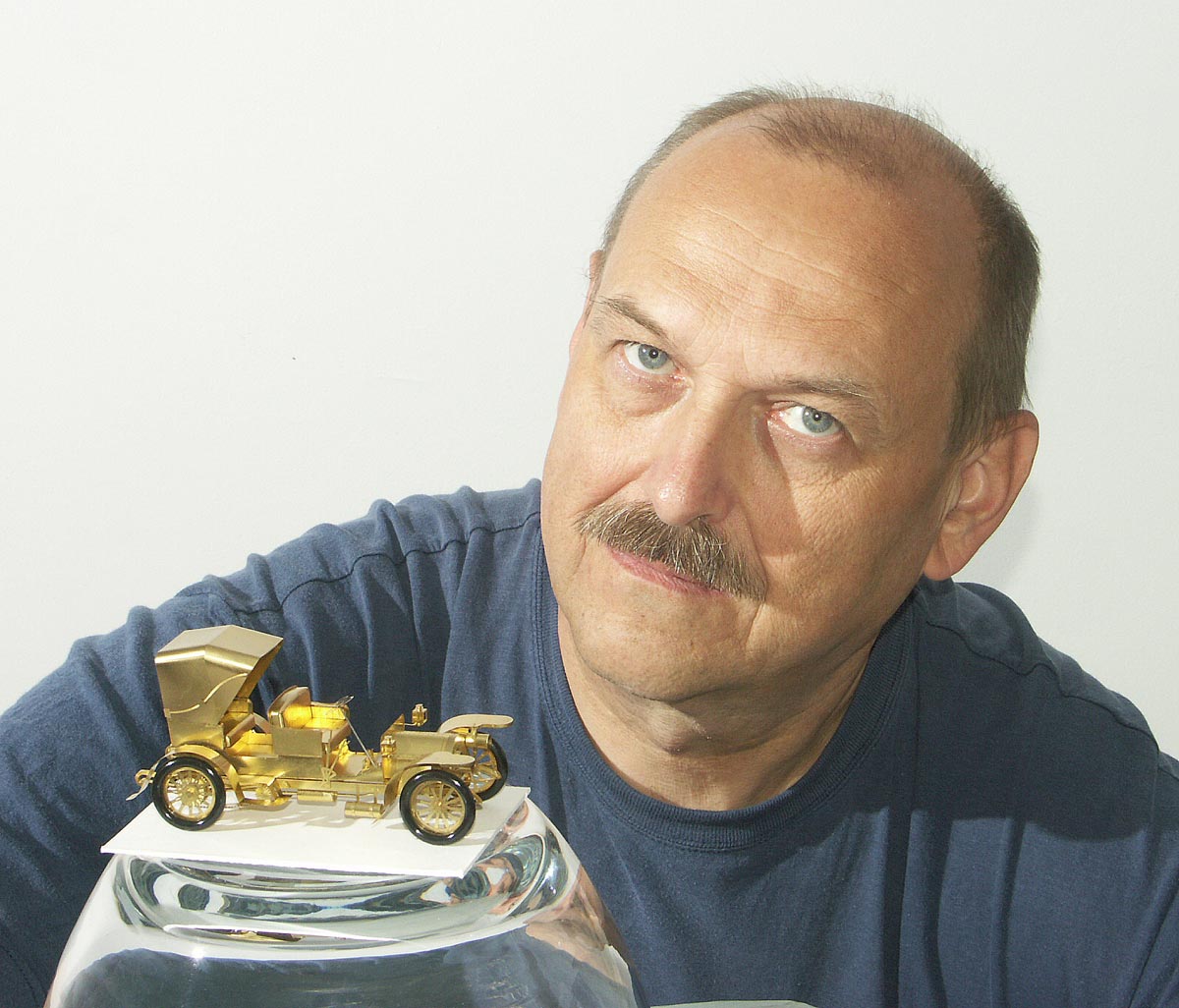 Szymon Klimek with one of his miniature brass models. 