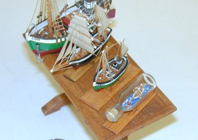 A table with several of Phil's tiny model ships.