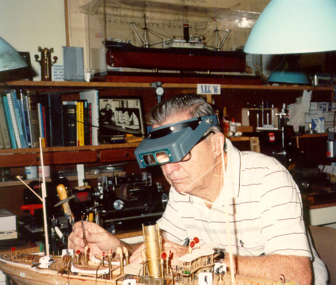 Phil Mattson working on his USS Bennington model in his home shop. 