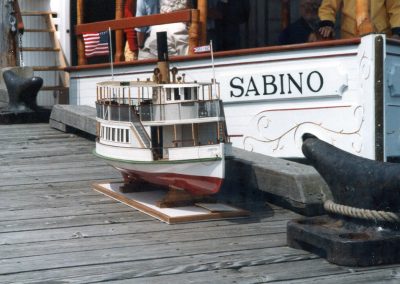 Chris' model of the Sabino sitting in front of the real ship.