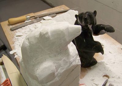 Carving a bear out of stone.