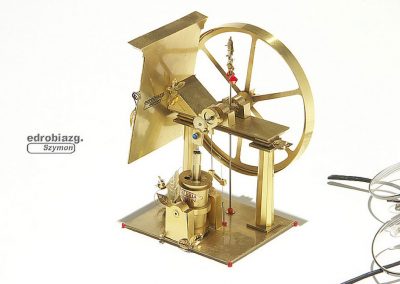 A tiny brass oscillating steam engine.