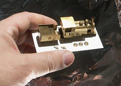 A tiny brass locomotive and tender.