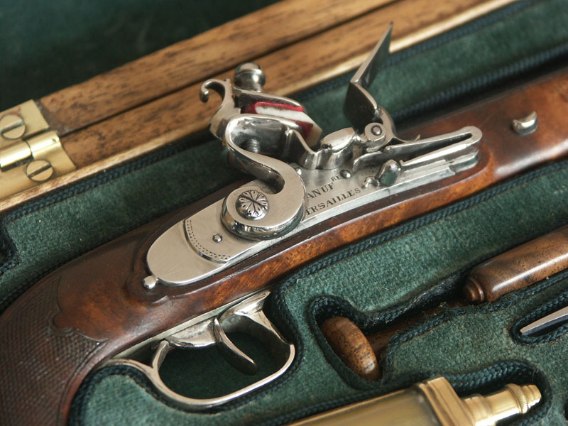 A close look at the flintlock plate on the Boutet pistol.