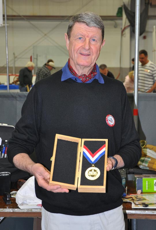 Michel holding his commemorative gold medallion. 