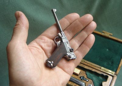 The miniature Navy Luger sits in Michel’s palm.