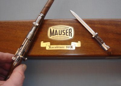 Michel’s 1/3 scale rifle and bayonet on the lid of a custom walnut chest.