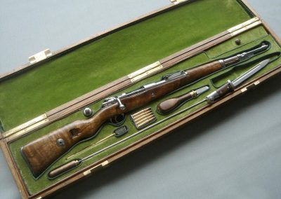 A miniature presentation of the encased 1/3 scale Mauser 98K rifle.